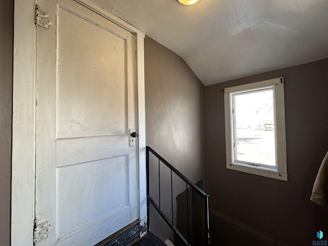 staircase featuring lofted ceiling