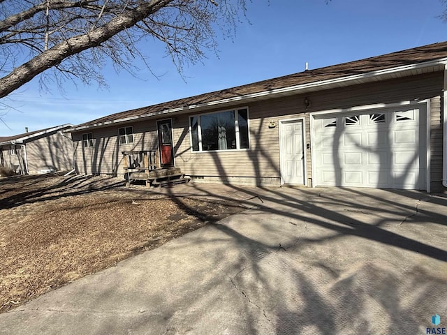 view of front of house with concrete driveway and an attached garage