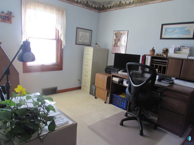 office space with carpet flooring, baseboards, and visible vents