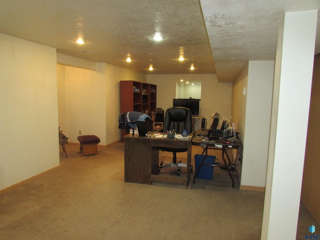 carpeted office space featuring a textured ceiling and baseboards