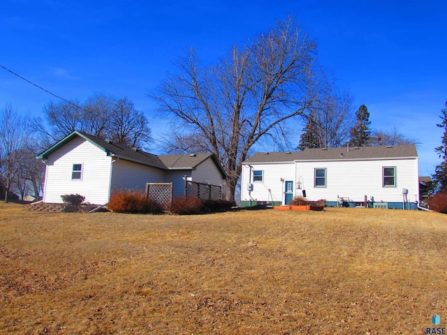 back of property with a lawn