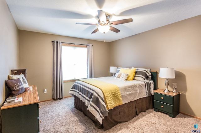 bedroom featuring baseboards, light colored carpet, and ceiling fan