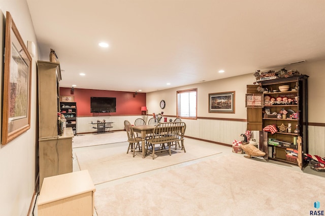 dining space featuring recessed lighting, a wainscoted wall, and carpet