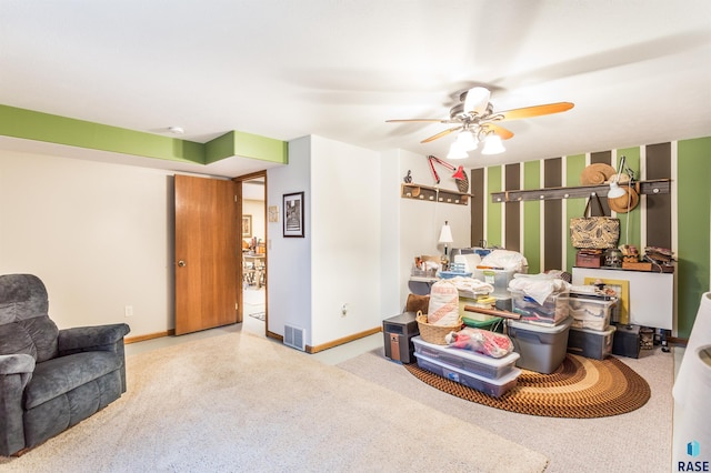 interior space featuring visible vents, baseboards, a ceiling fan, and carpet flooring