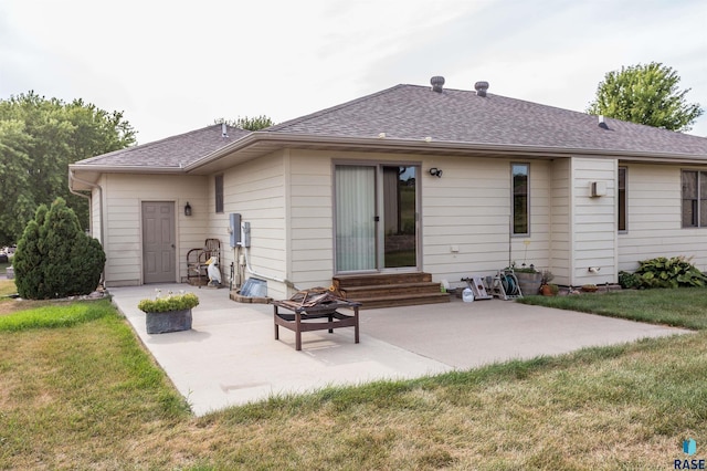 rear view of house with a yard, a patio, a shingled roof, and entry steps