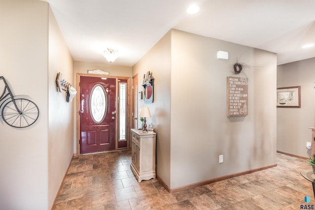 entryway with stone finish flooring and baseboards