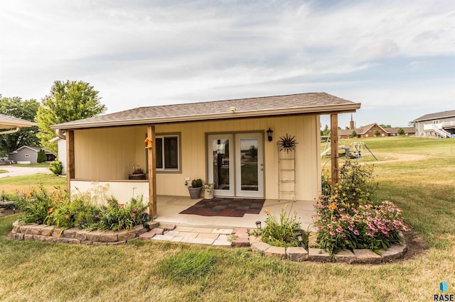 exterior space with a lawn and roof with shingles