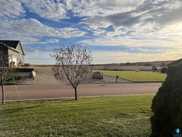 view of yard featuring a rural view and a garage