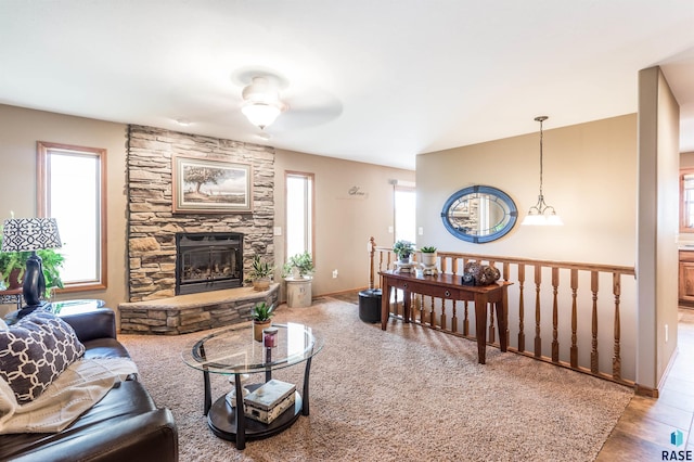 living room featuring plenty of natural light, a fireplace, and baseboards