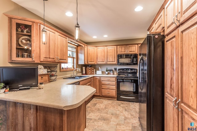 kitchen featuring black appliances, pendant lighting, a sink, a peninsula, and light countertops