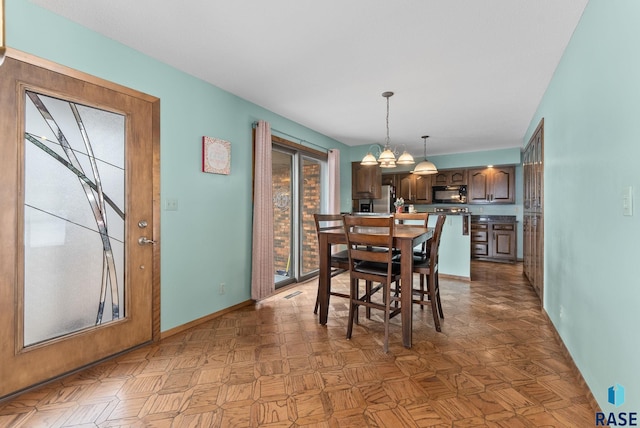 dining space featuring baseboards