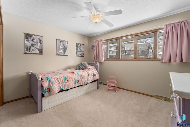 bedroom with visible vents, baseboards, carpet, and a textured ceiling