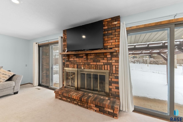 living area with a fireplace, baseboards, and carpet floors