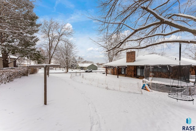 snowy yard with a trampoline