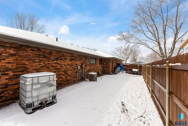 yard layered in snow with fence