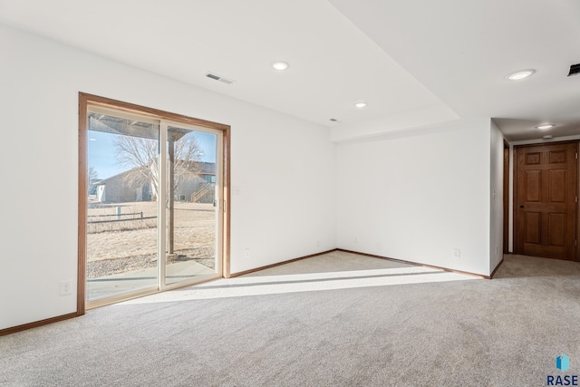 carpeted spare room with recessed lighting, baseboards, and visible vents