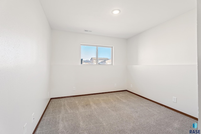 spare room with visible vents, baseboards, and carpet floors