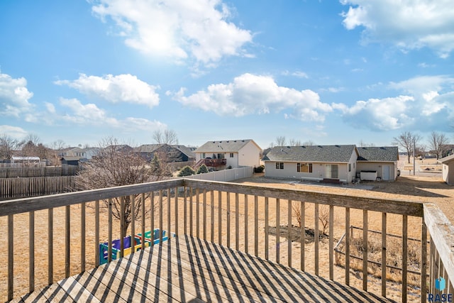 wooden deck with a residential view and a fenced backyard