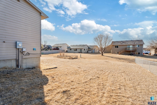 view of yard featuring a residential view and fence