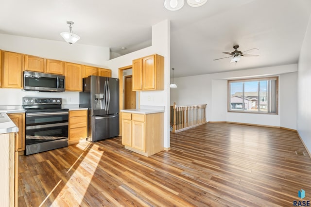 kitchen featuring appliances with stainless steel finishes, light brown cabinets, and light countertops