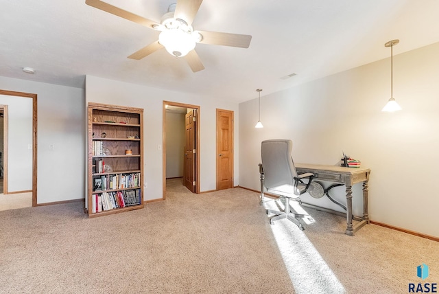 office area featuring baseboards, carpet floors, and ceiling fan