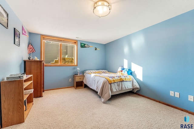 carpeted bedroom with baseboards