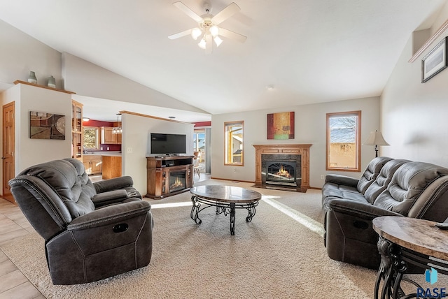 carpeted living area featuring a glass covered fireplace, a ceiling fan, and lofted ceiling