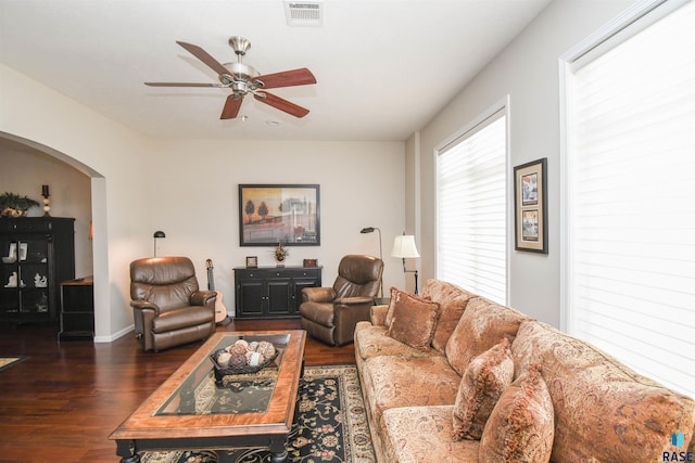 7434 S Louise Ave Unit 103, Sioux Falls, SD 57108 - living area featuring visible vents, ceiling fan, baseboards, dark wood-style floors, and arched walkways