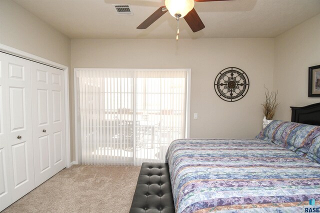 7434 S Louise Ave Unit 103, Sioux Falls, SD 57108 - carpeted bedroom featuring visible vents, multiple windows, a closet, and ceiling fan