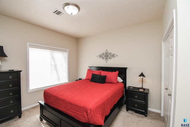 7434 S Louise Ave Unit 103, Sioux Falls, SD 57108 - bedroom featuring baseboards, visible vents, and light carpet