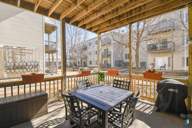 7434 S Louise Ave Unit 103, Sioux Falls, SD 57108 - wooden deck with outdoor dining space, a residential view, and a grill