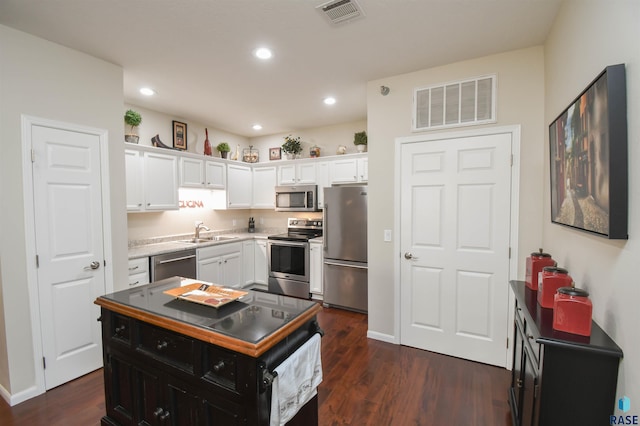 7434 S Louise Ave Unit 103, Sioux Falls, SD 57108 - kitchen with a sink, white cabinets, visible vents, and stainless steel appliances