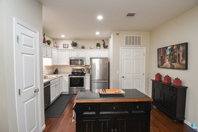 7434 S Louise Ave Unit 103, Sioux Falls, SD 57108 - kitchen featuring a sink, visible vents, white cabinetry, and stainless steel appliances
