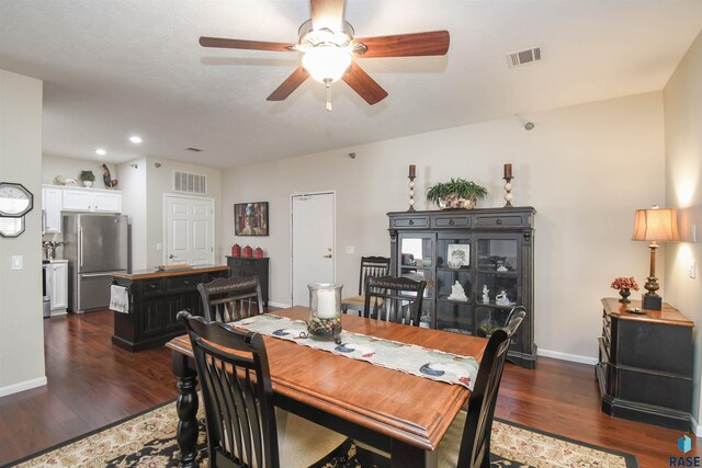 7434 S Louise Ave Unit 103, Sioux Falls, SD 57108 - dining room featuring visible vents, baseboards, and dark wood-style flooring