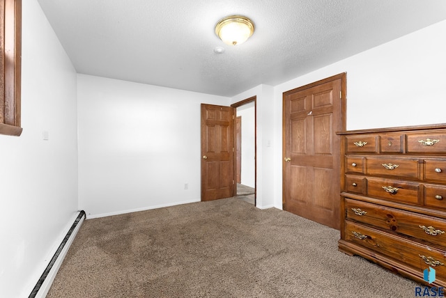 unfurnished bedroom featuring carpet flooring, a textured ceiling, baseboards, and a baseboard radiator