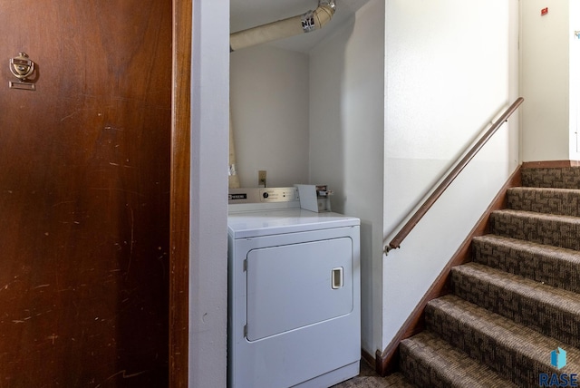 laundry area with laundry area and washer / dryer