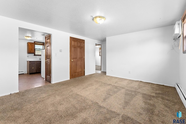 unfurnished bedroom featuring a baseboard radiator, carpet, baseboard heating, and a textured ceiling