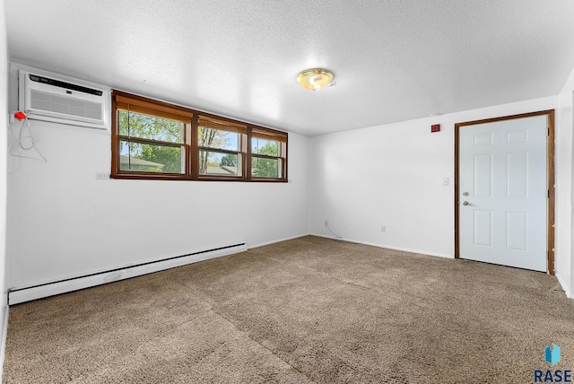 carpeted spare room featuring a wall mounted air conditioner, a baseboard radiator, and a textured ceiling