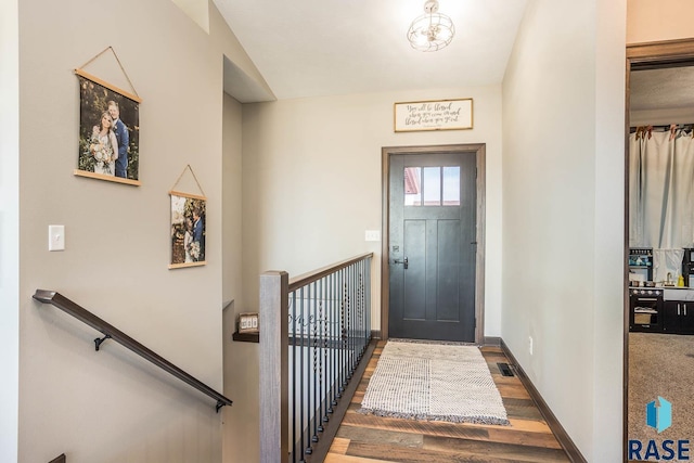 entrance foyer featuring visible vents, baseboards, and wood finished floors