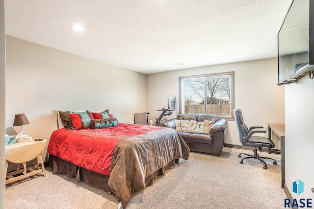 carpeted bedroom featuring baseboards and a textured ceiling