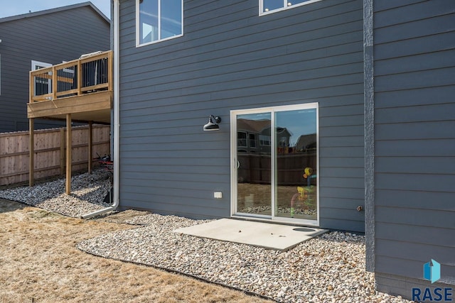 back of house featuring a wooden deck and fence