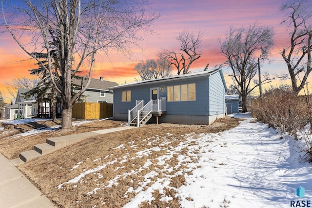 view of front of home featuring fence