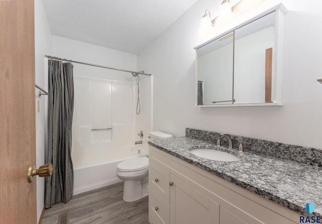 full bathroom with vanity, shower / bathtub combination with curtain, wood finished floors, visible vents, and toilet