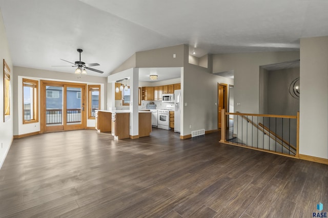 unfurnished living room featuring baseboards, visible vents, dark wood finished floors, lofted ceiling, and ceiling fan