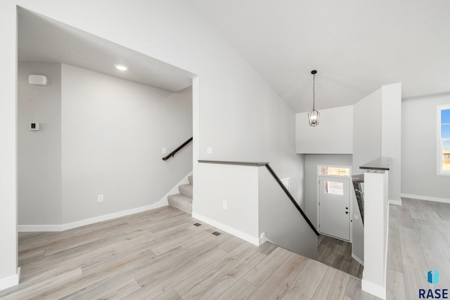 entrance foyer featuring recessed lighting, baseboards, lofted ceiling, and wood finished floors