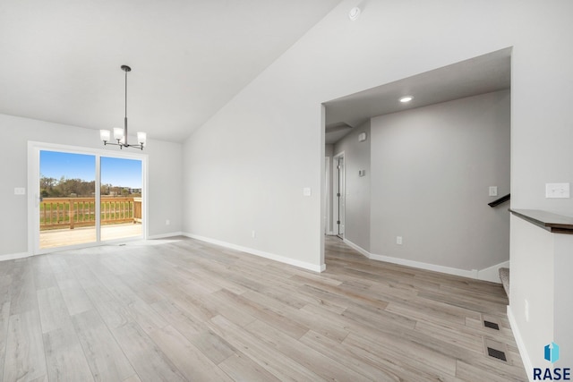 unfurnished living room featuring visible vents, baseboards, light wood-type flooring, a notable chandelier, and high vaulted ceiling