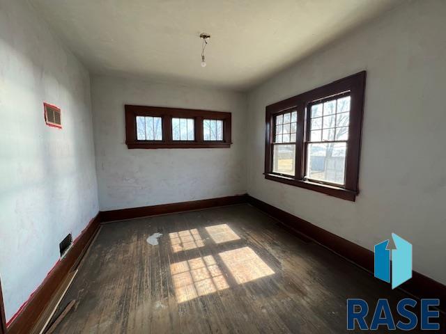 unfurnished room featuring wood finished floors and baseboards