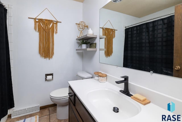 bathroom featuring vanity, a shower with shower curtain, visible vents, tile patterned floors, and toilet