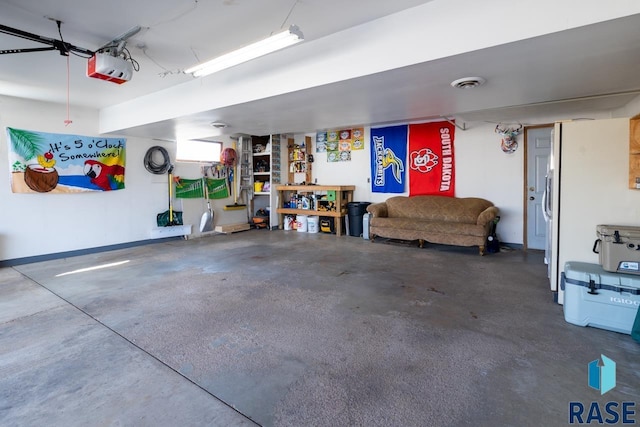 garage with visible vents, baseboards, and a garage door opener