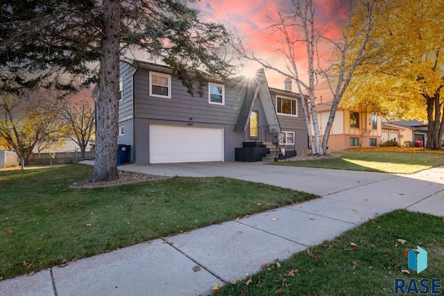 view of front of property featuring brick siding, a garage, driveway, and a front yard